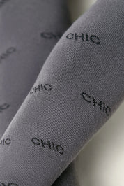 Gray socks with 'CHIC' text pattern on a light background #color_dark-gray