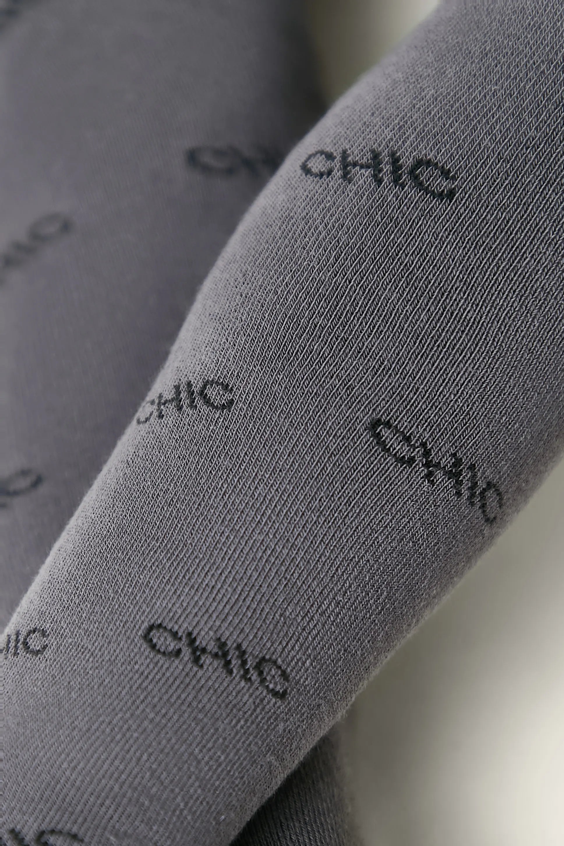 Gray socks with 'CHIC' text pattern on a light background #color_dark-gray
