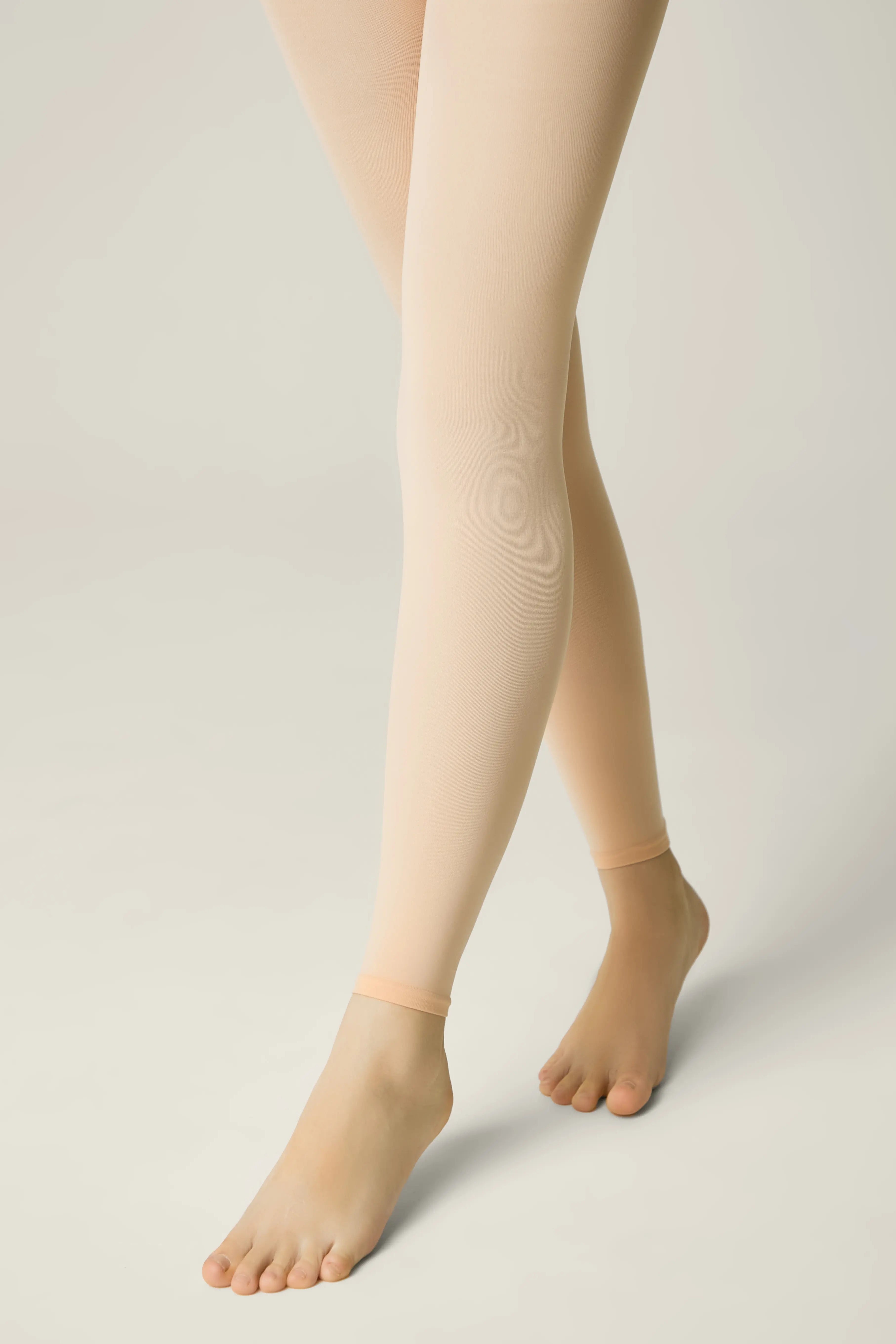 Beige tights worn by a person on a plain background #color_pink-ballet
