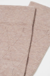 Two folded beige fabric swatches on a white background #color_beige