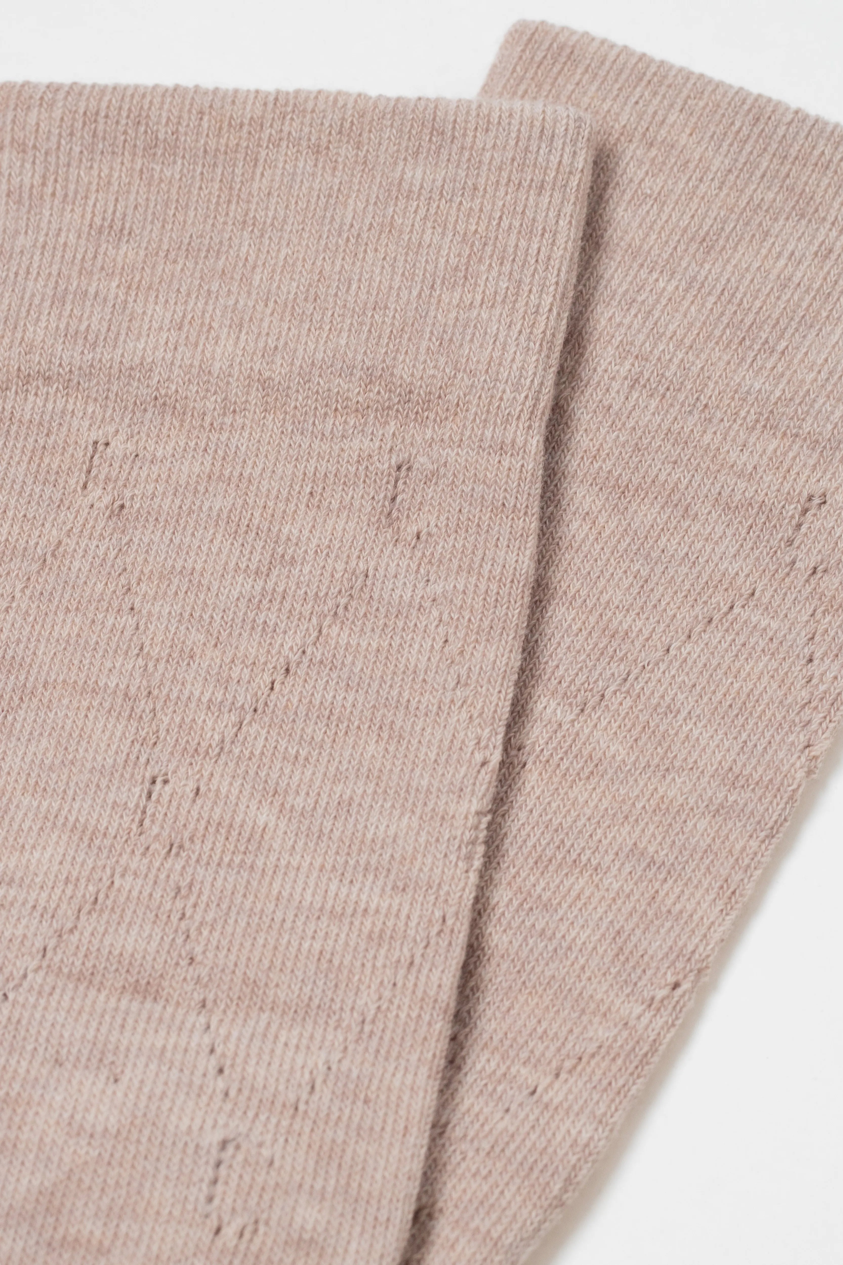 Two folded beige fabric swatches on a white background #color_beige