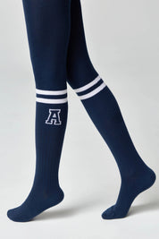 Navy knee-high socks with white stripes and a letter 'A' on a plain background
