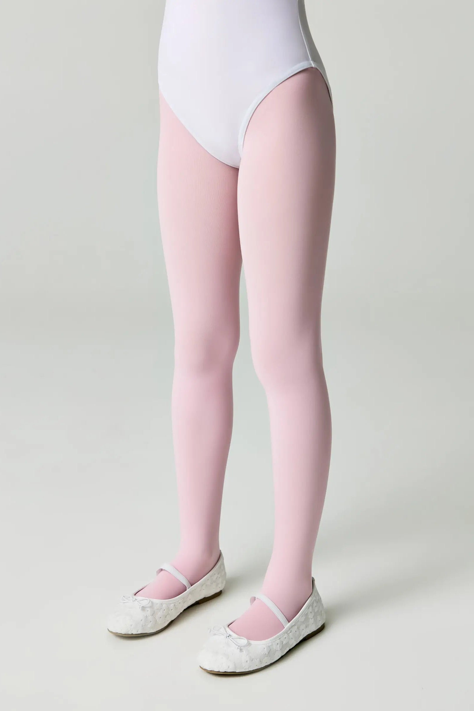 Person wearing a white bodysuit and pink tights on a plain background #color_pink