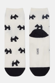White socks with black dog patterns and a black heel and toe on a white background #color_milk