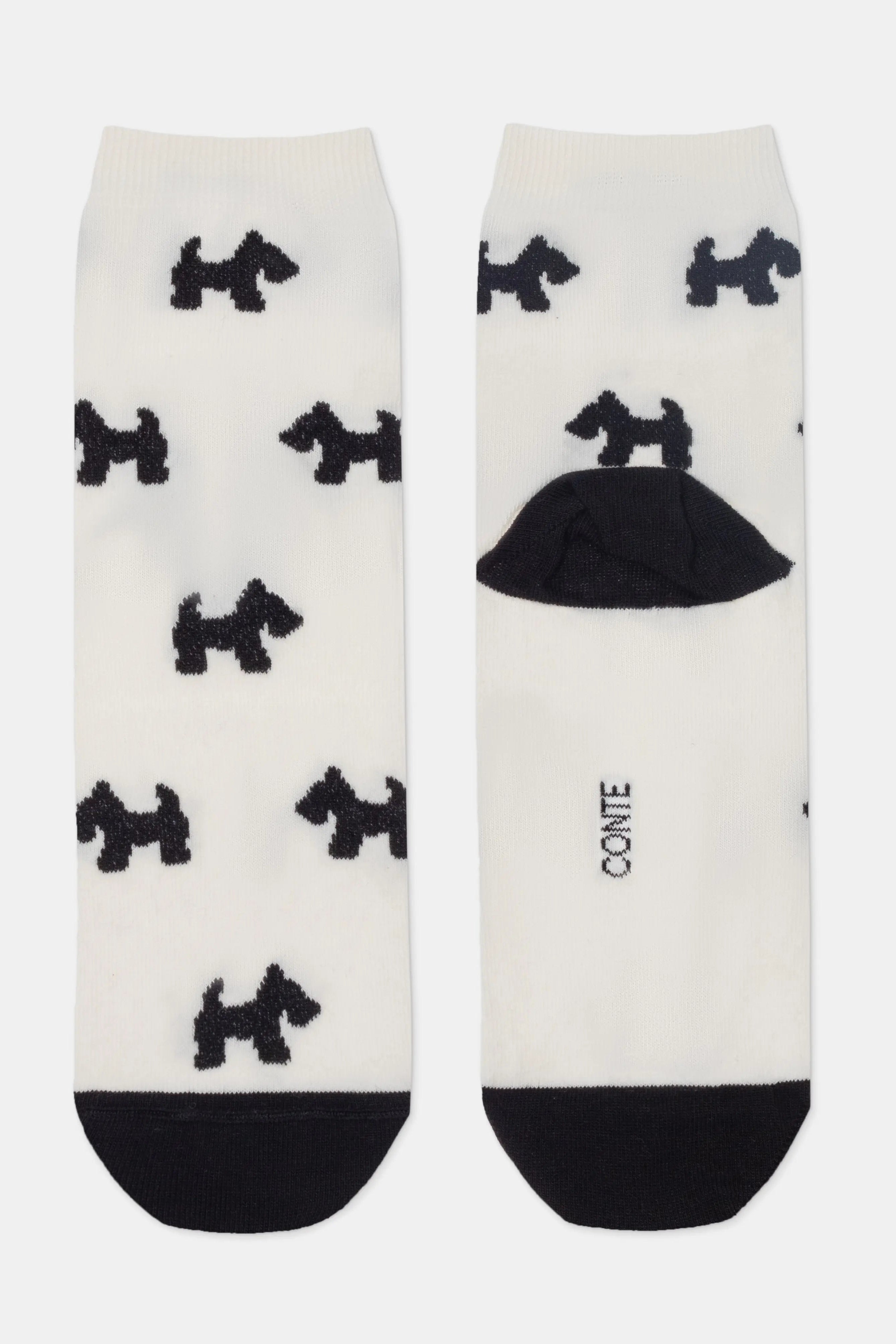 White socks with black dog patterns and a black heel and toe on a white background #color_milk