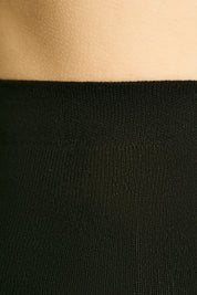 Close-up of a black garment with a beige top