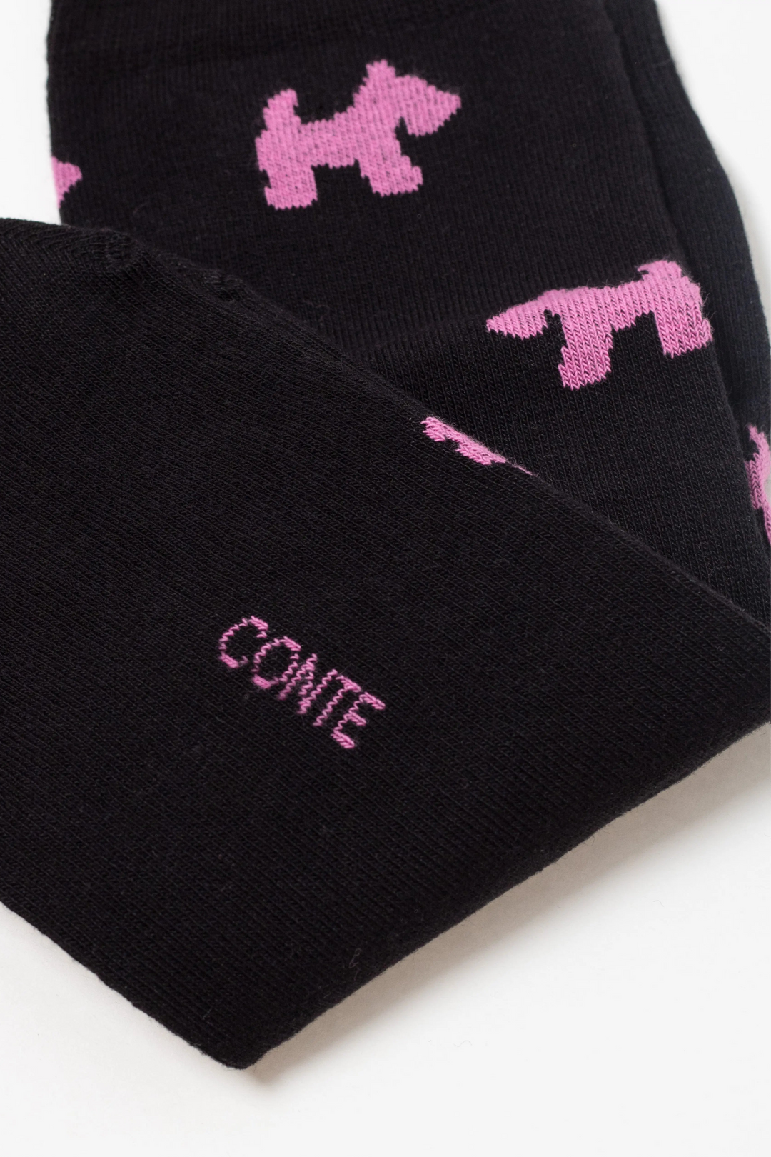 Black socks with pink dog patterns and 'Conte' branding on a white background  #color_black