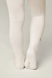 White tights worn by a person on a light gray background #color_milky