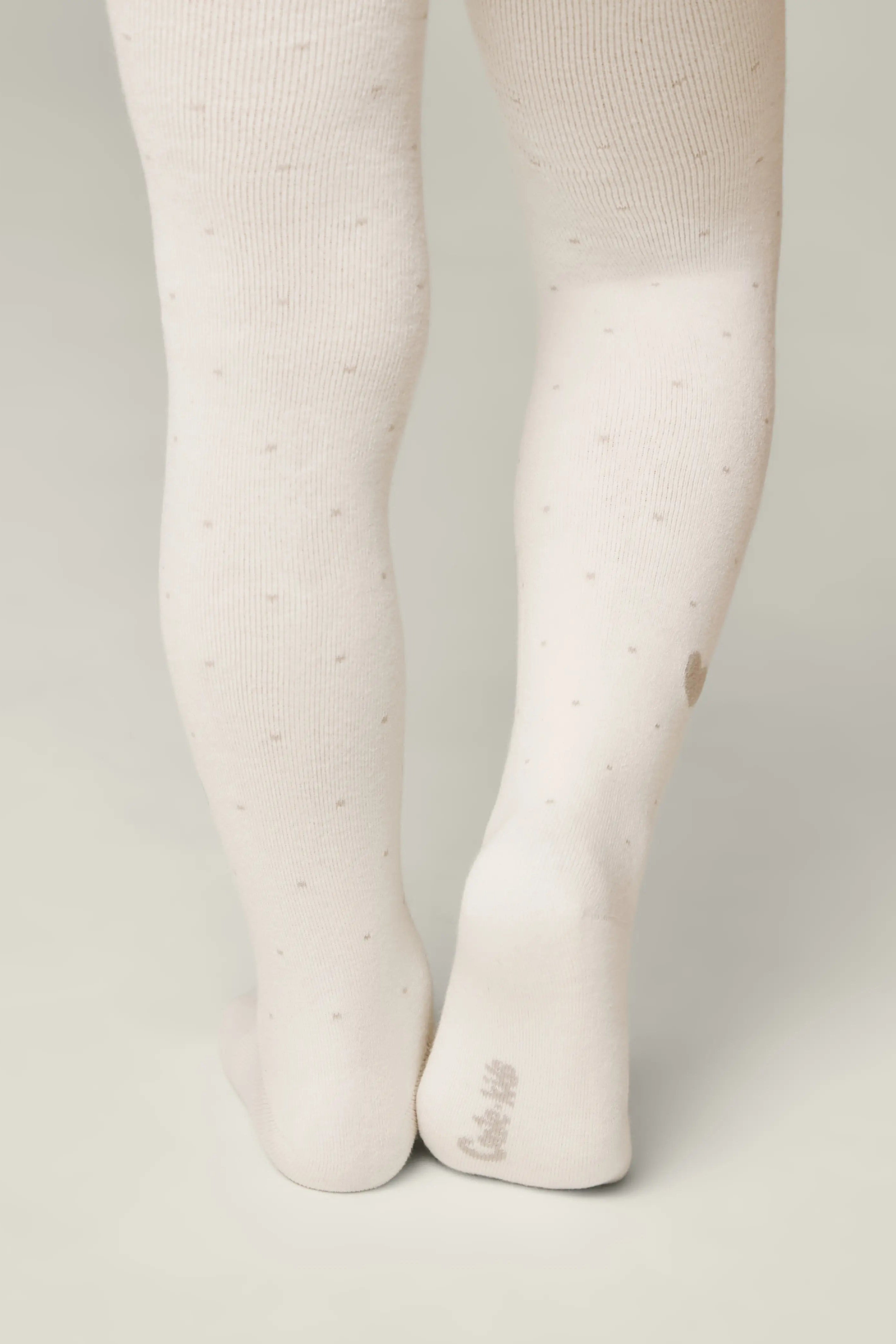 White tights worn by a person on a light gray background #color_milky