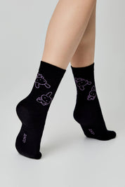 Black socks with cat designs on a white background