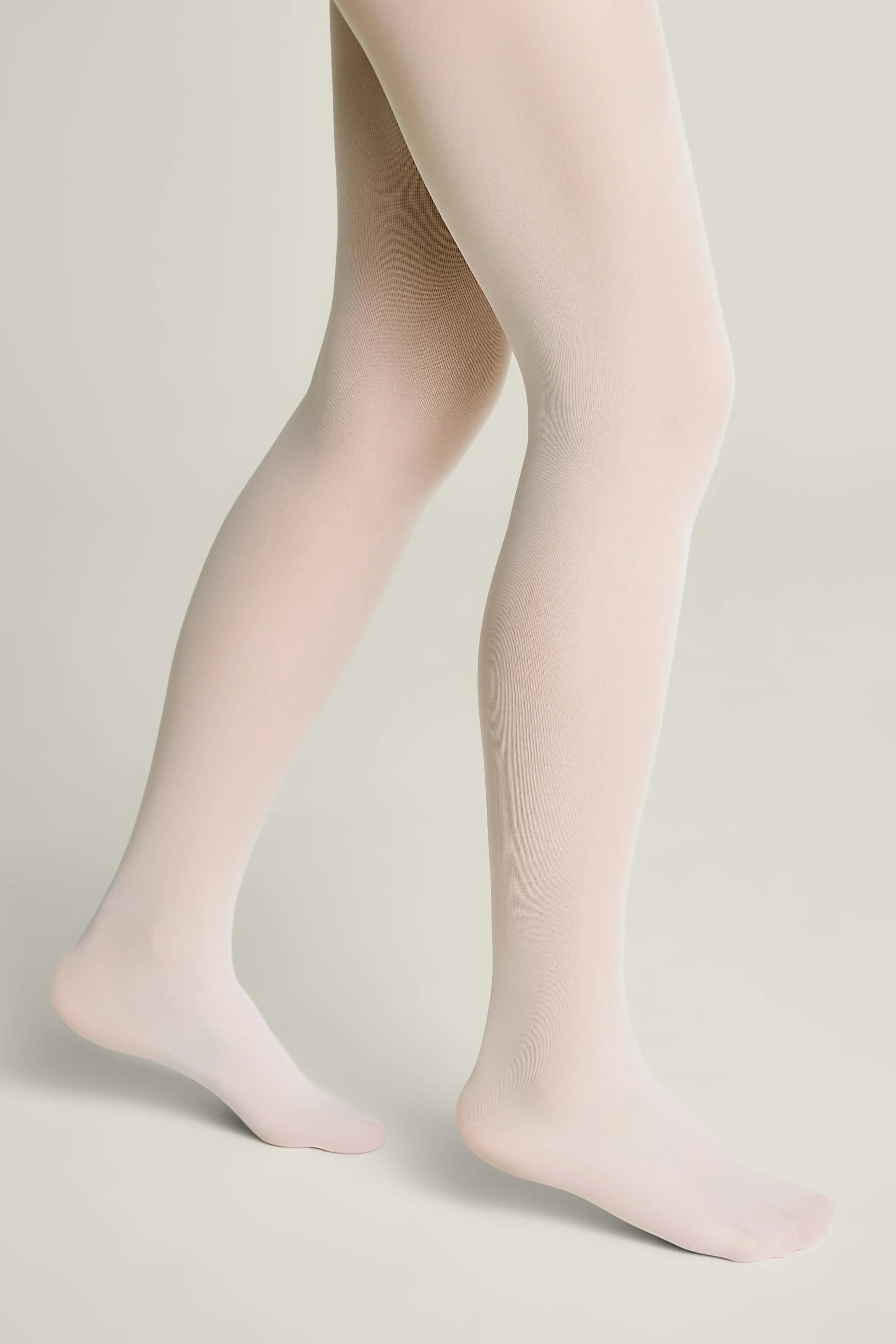 Light pink tights worn by a person on a neutral background #color_bianco