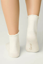 White ankle socks worn by a person on a light gray background #color_milky