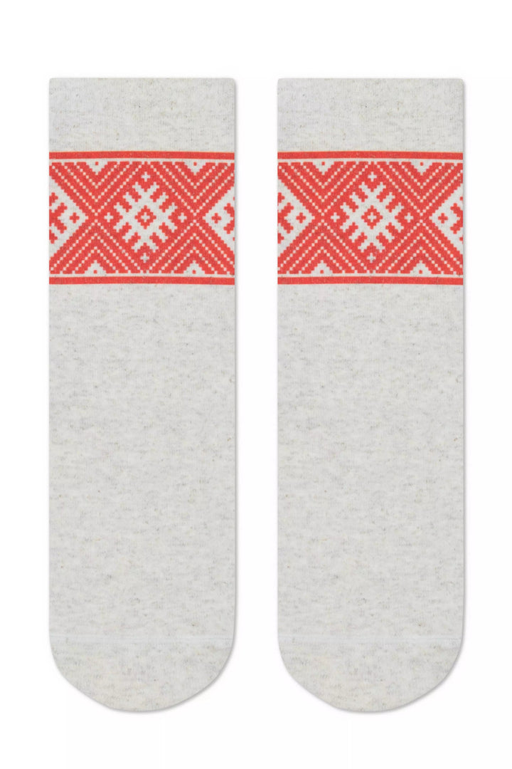 Pair of gray socks with red and white pattern on a white background