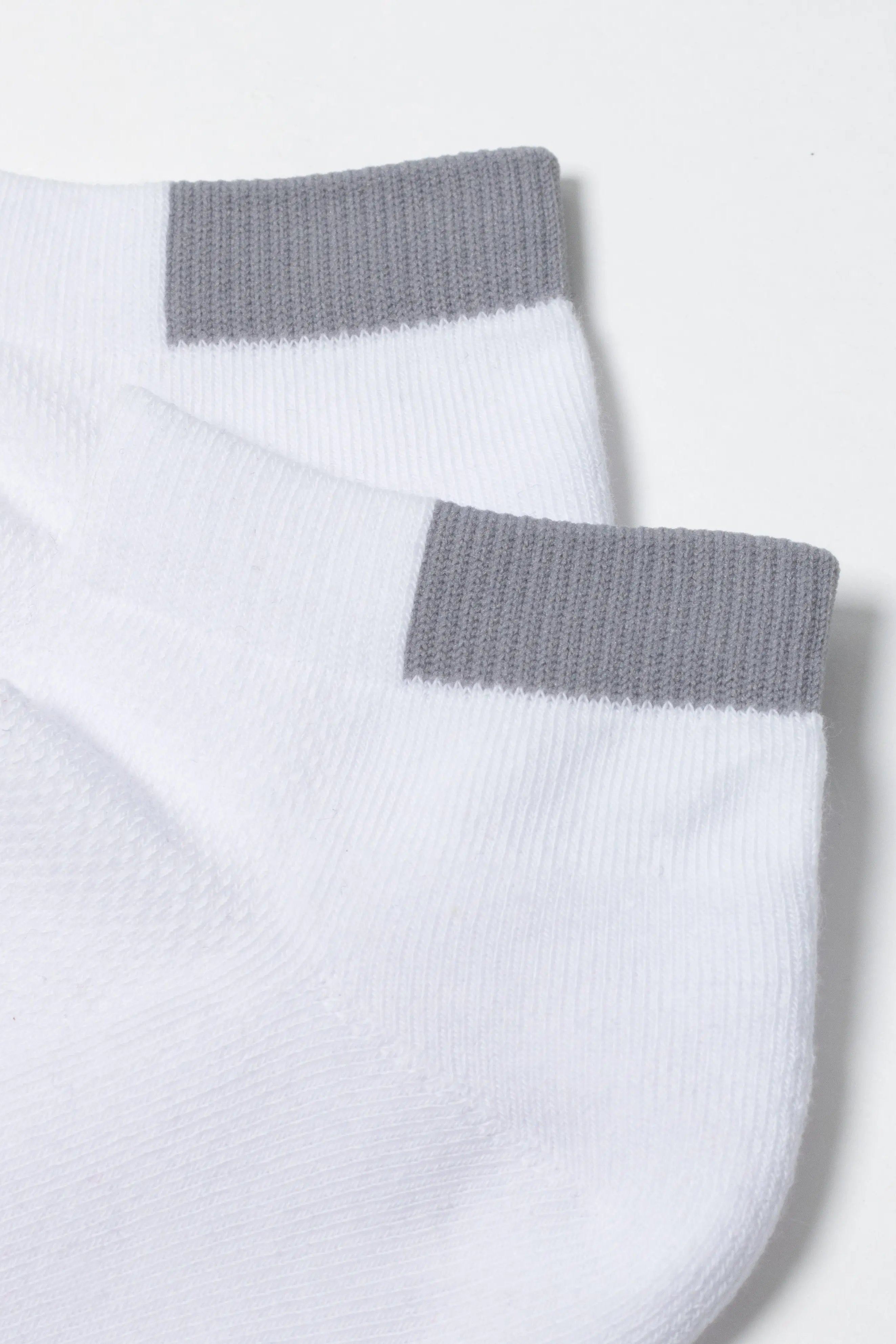 White ankle socks with gray cuffs on a light gray background #color_white