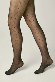 Black patterned tights worn by a person on a beige background #color_nero-black