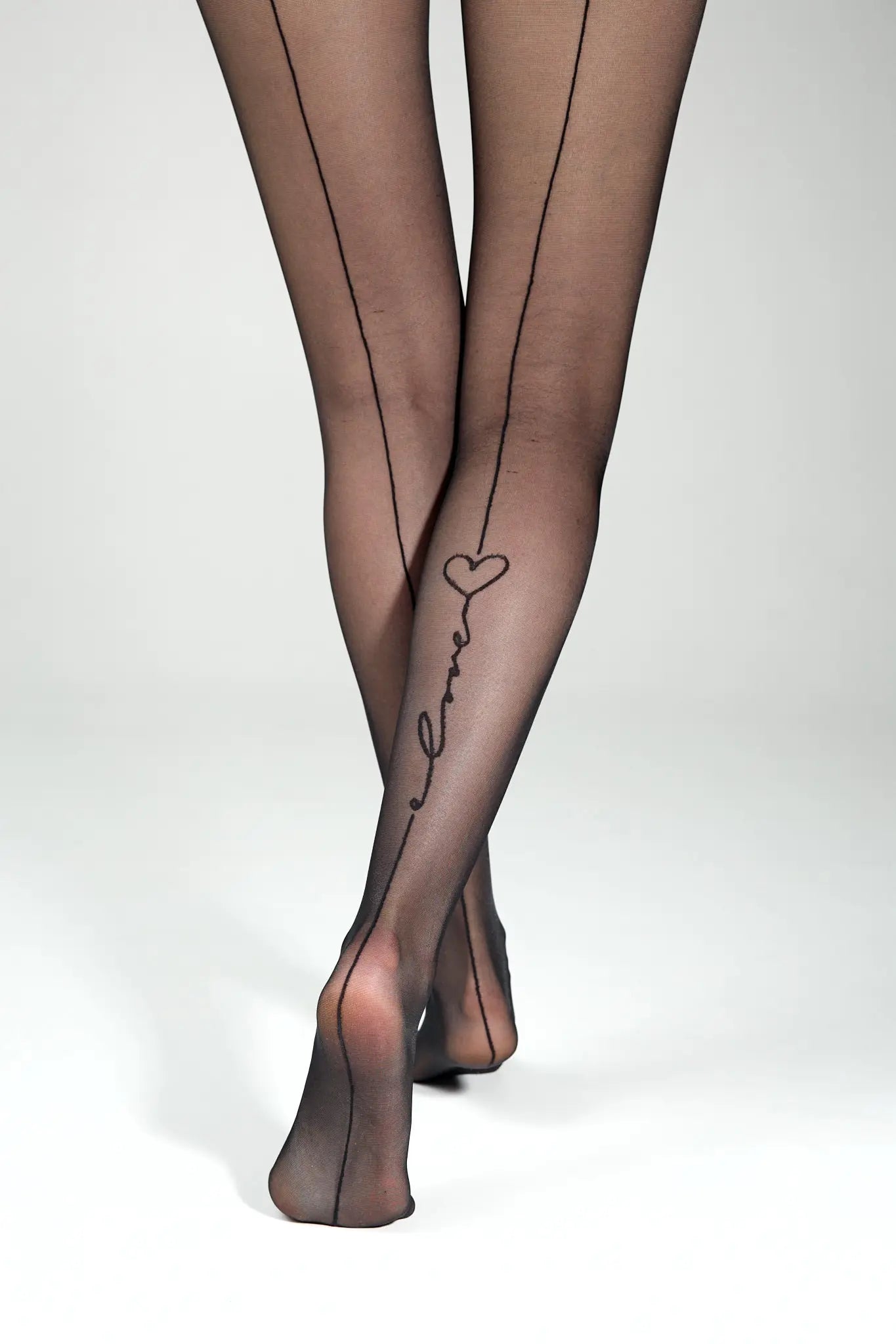 Black sheer stockings with 'love' and heart design on a white background