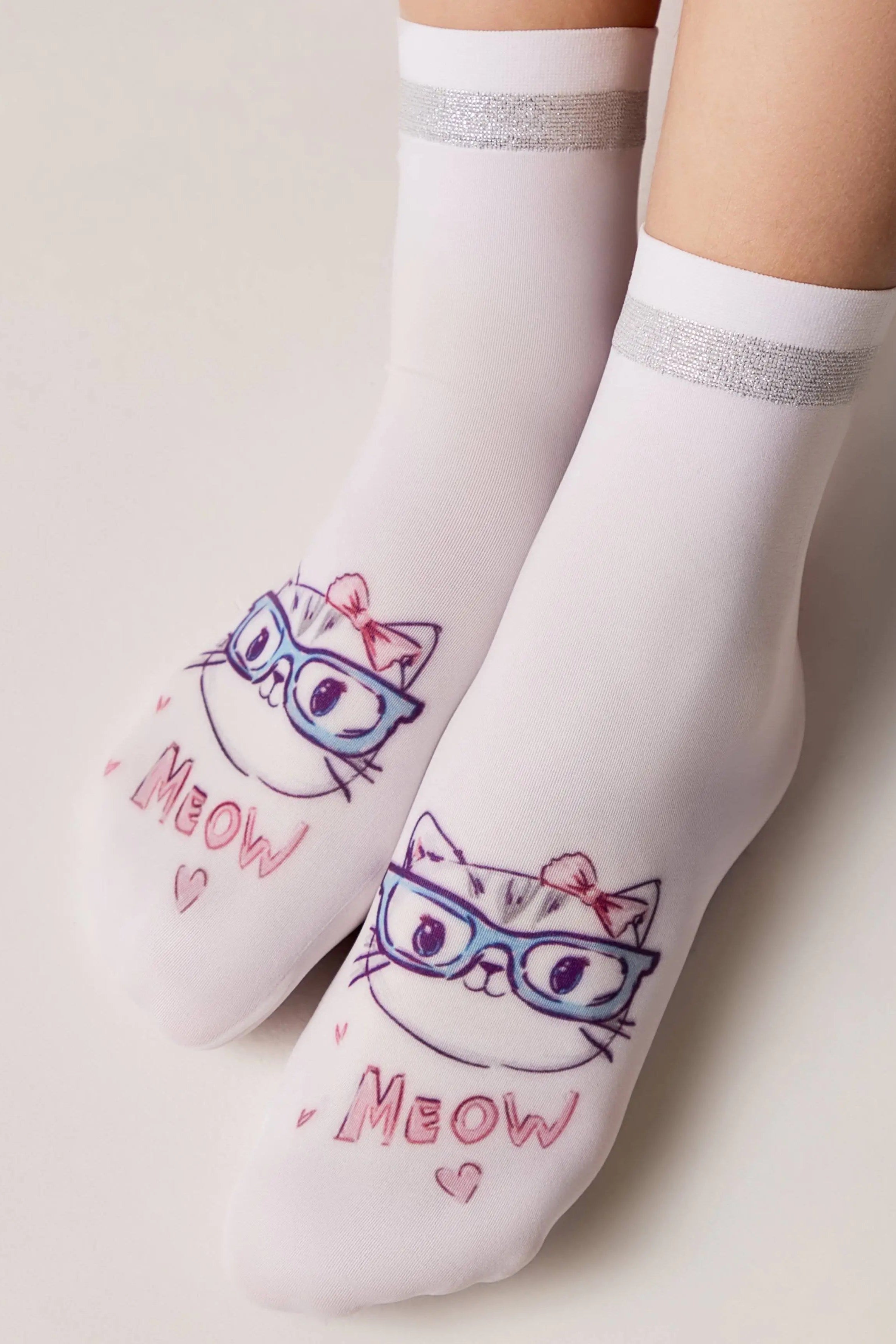 White socks with cat designs and 'MEOW' text on a light background