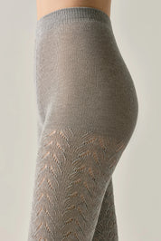 Close-up of gray patterned tights on a neutral background #color_grey