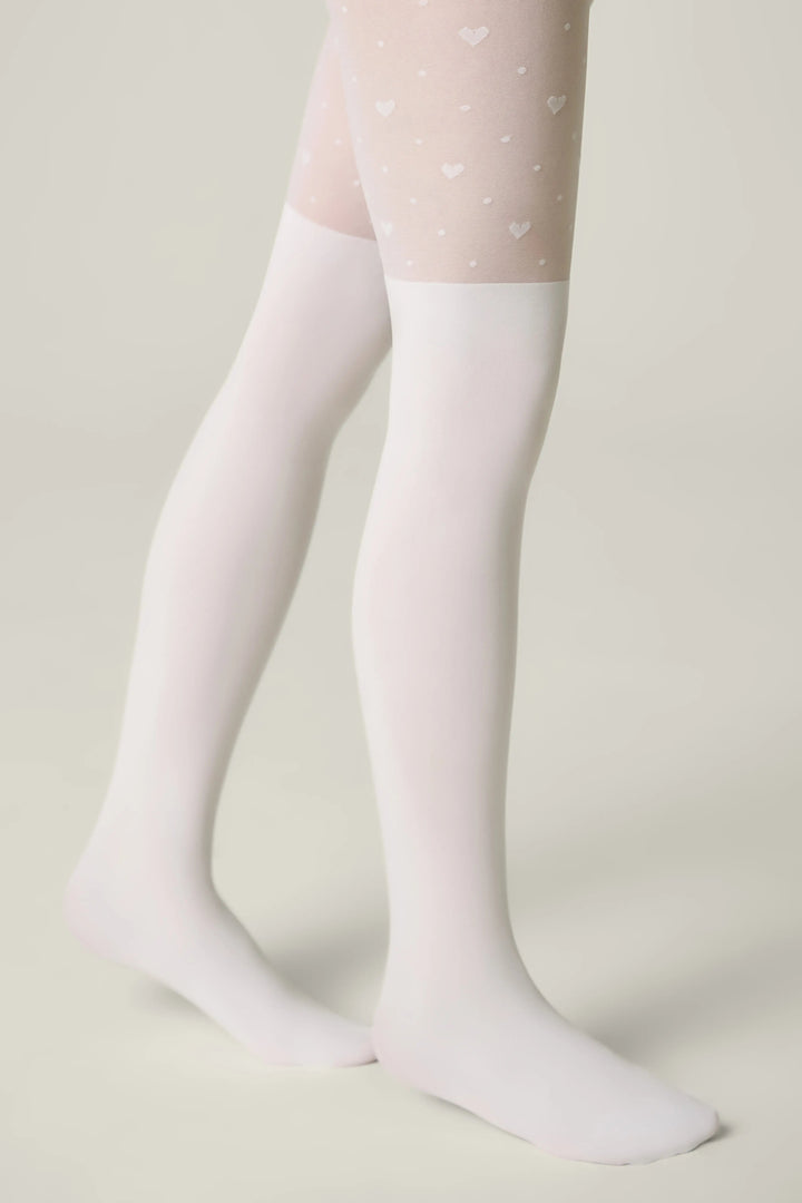 White tights with heart patterns worn by a person on a light background #color_bianco