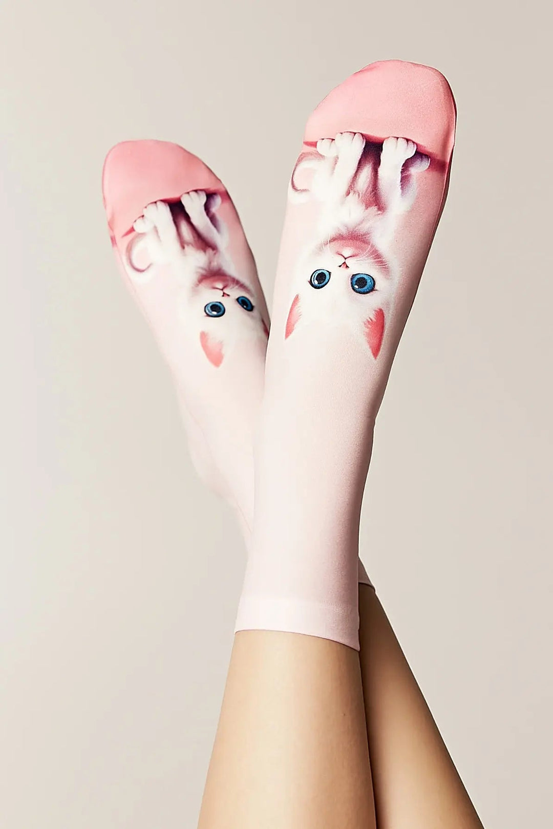 Pink socks with cartoon character design on a neutral background