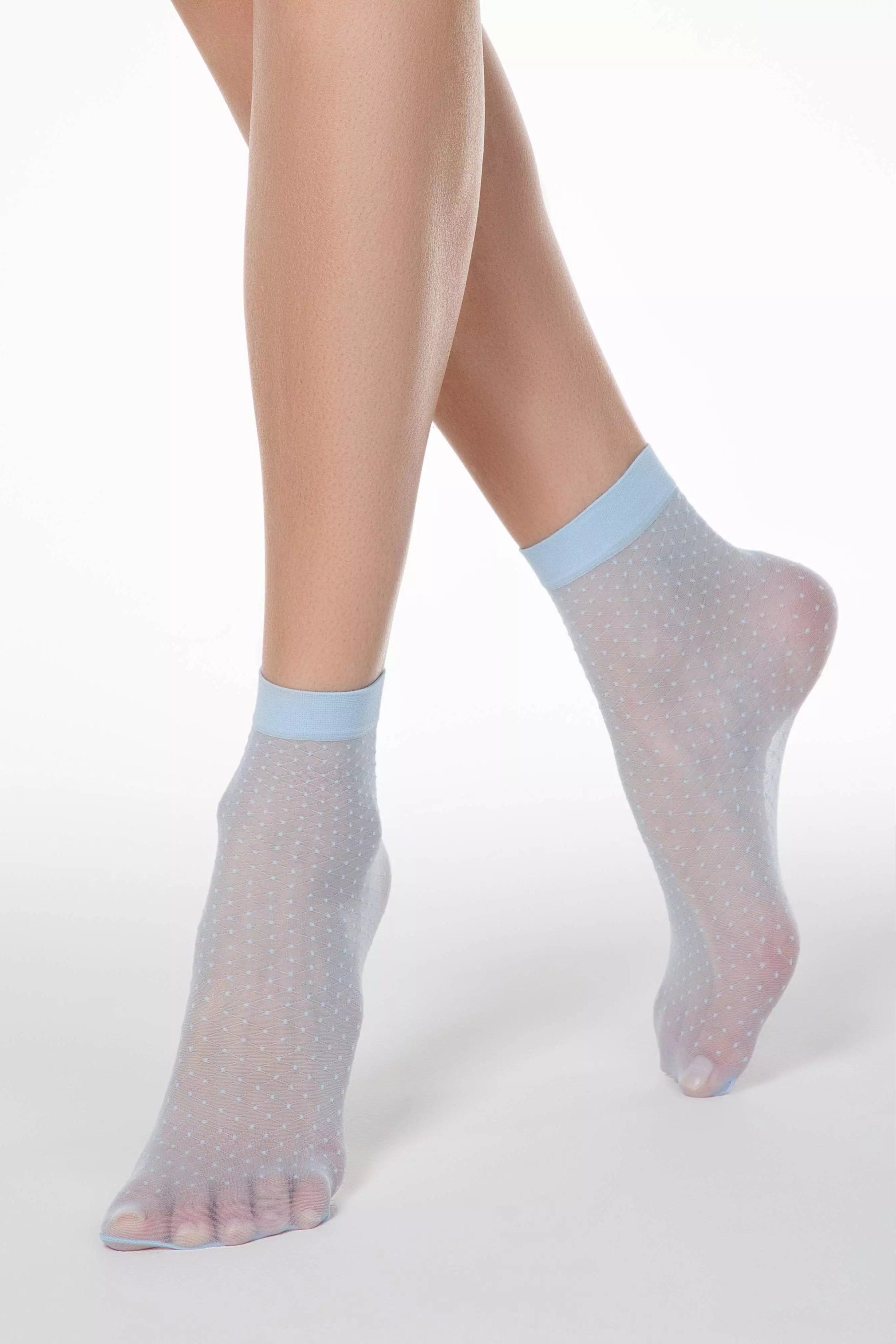 Transparent socks with light blue accents worn by a person on a white background #color_light-blue