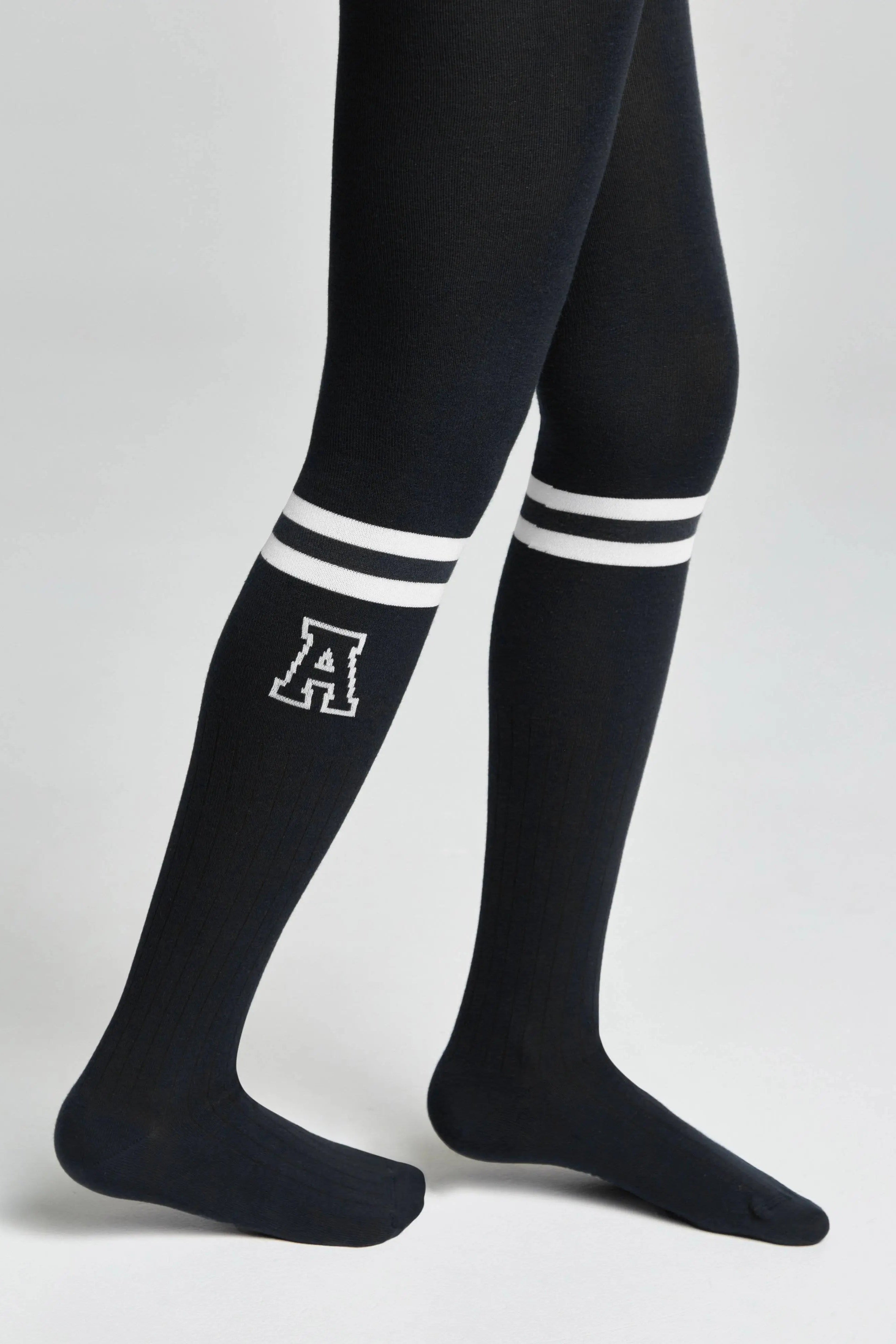 Black knee-high socks with white stripes and a logo on a light gray background