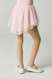 Person wearing a pink skirt and white shoes on a plain background #color_natural-nude