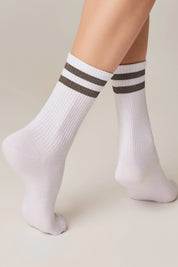 White socks with gray stripes worn by a person on a beige background #color_gray
