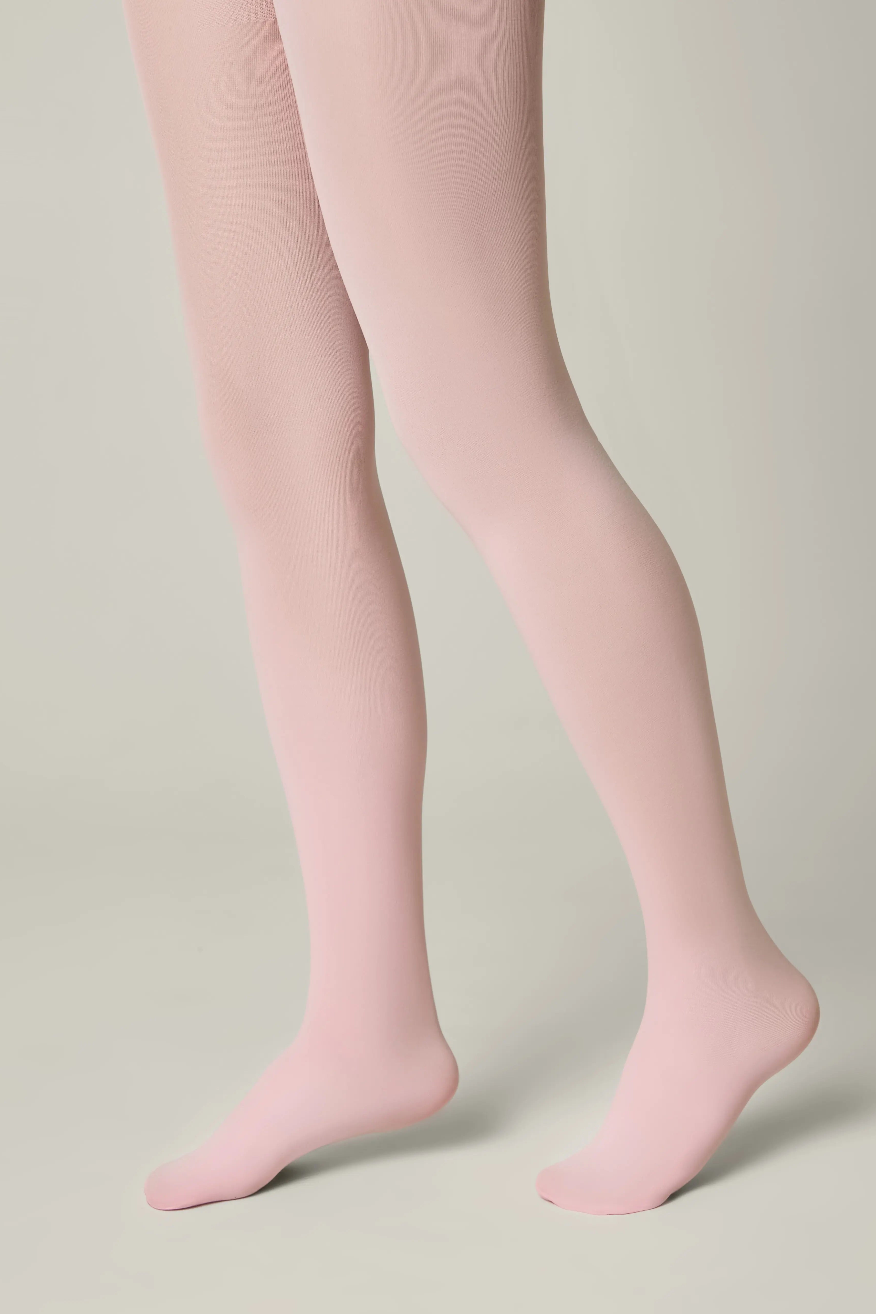 Pink tights worn by a person on a neutral background #color_pink