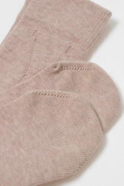 Close-up of a pair of beige socks on a white background #color_beige