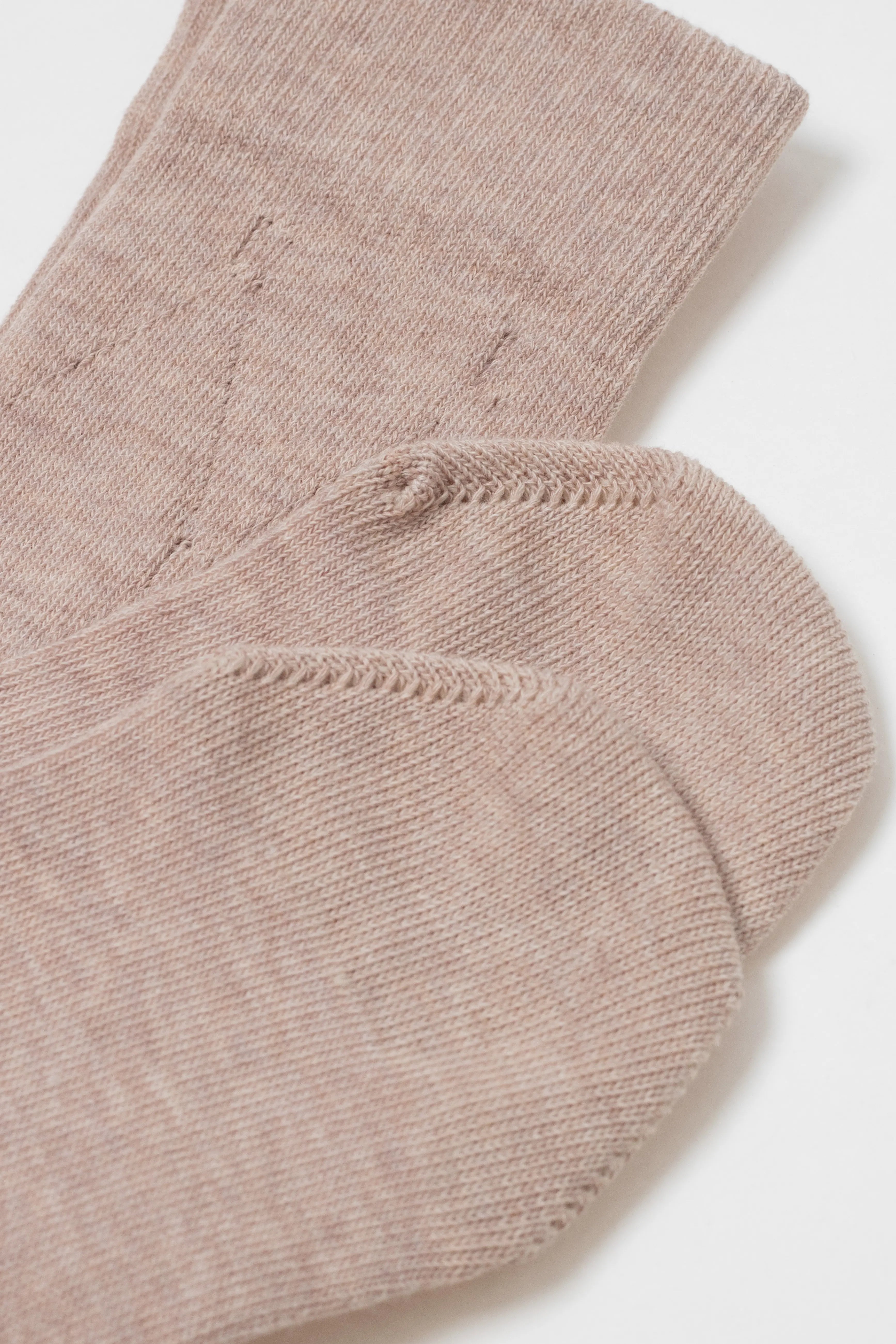 Close-up of a pair of beige socks on a white background #color_beige