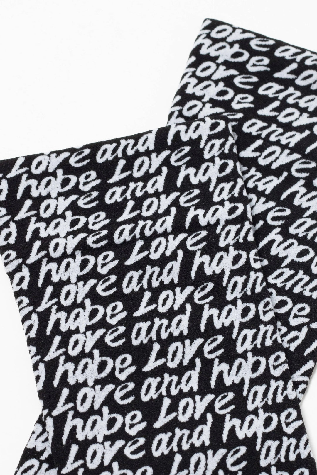 Black socks with 'love and hope' text pattern on a white background #color_nero-bianco