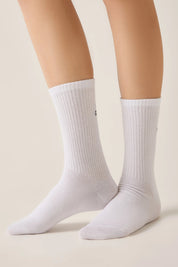 White socks worn by a person on a beige background