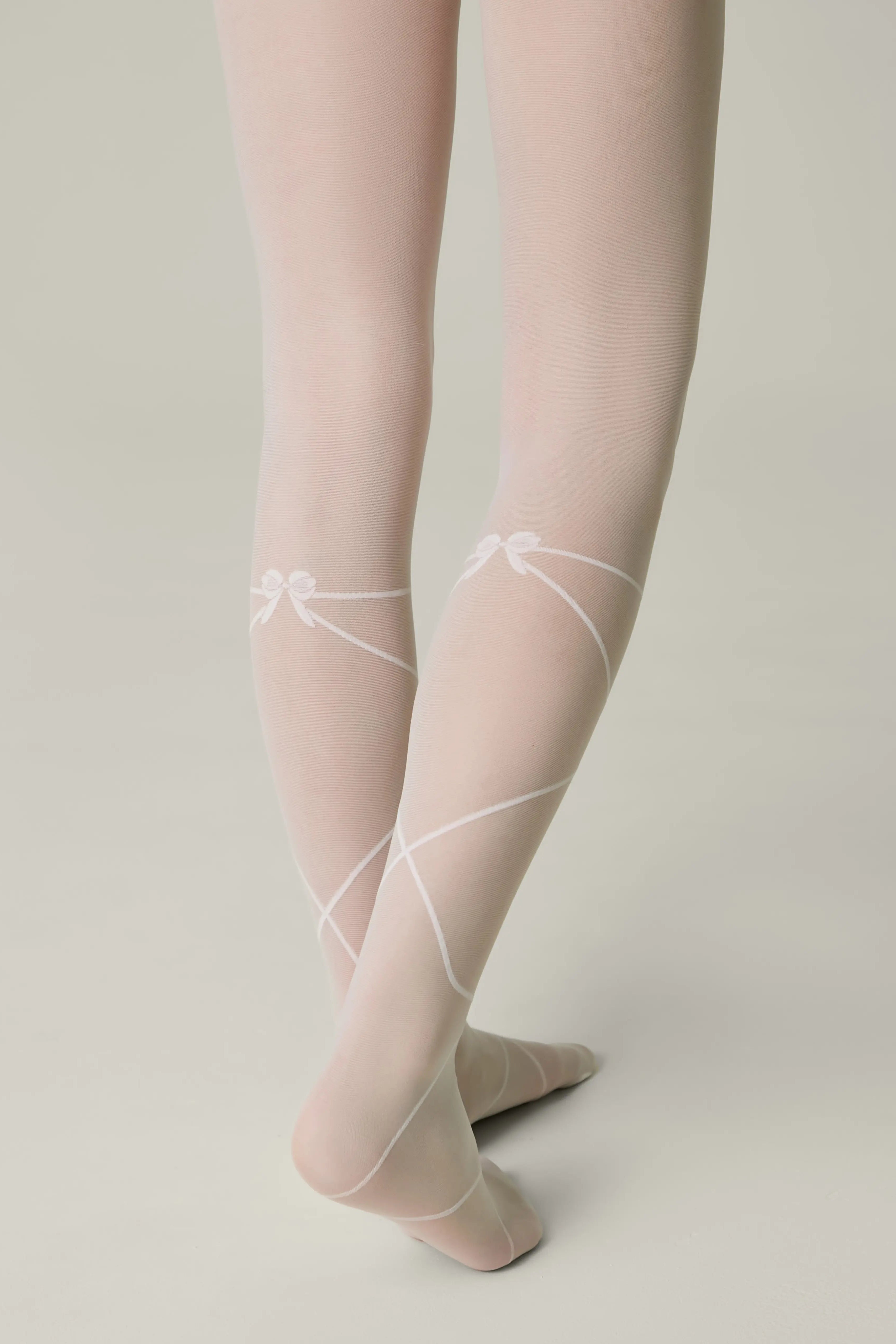 Sheer white stockings with lace details on a neutral background #color_bianco