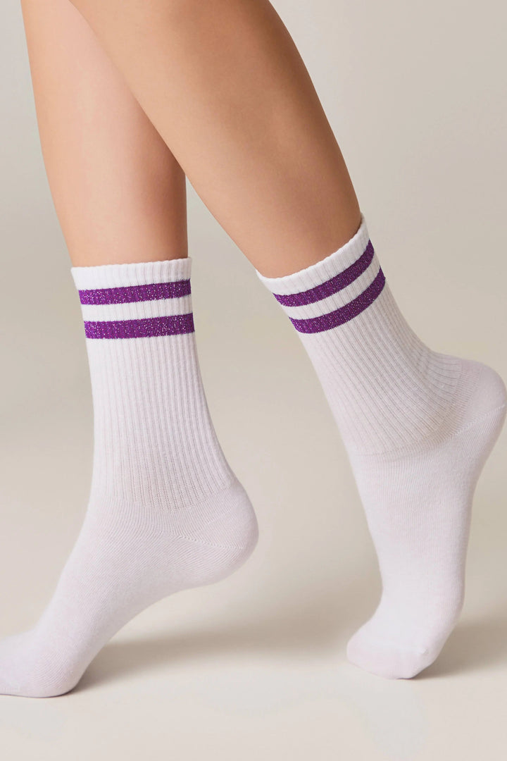 White socks with purple stripes worn by a person on a neutral background #color_lilac