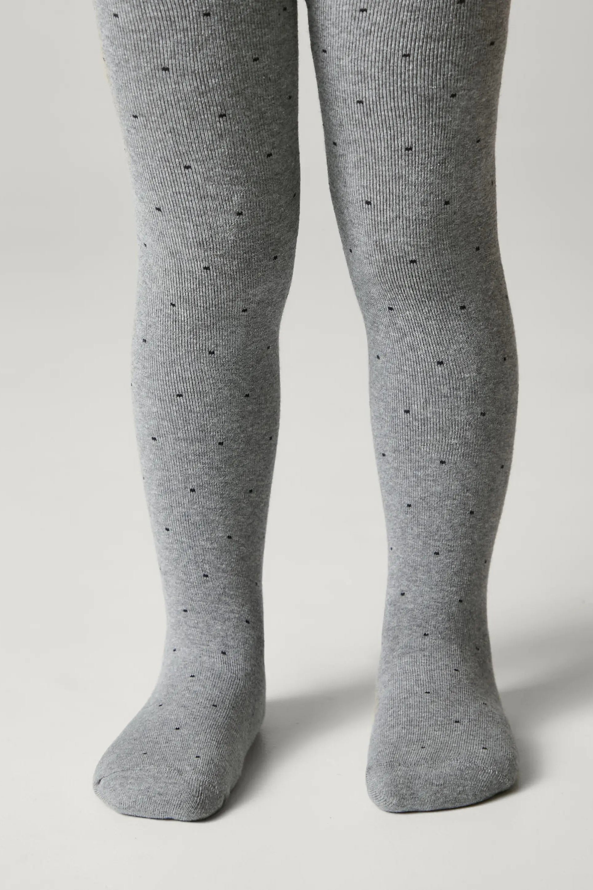 Gray tights with small black dots on a light gray background #color_gray