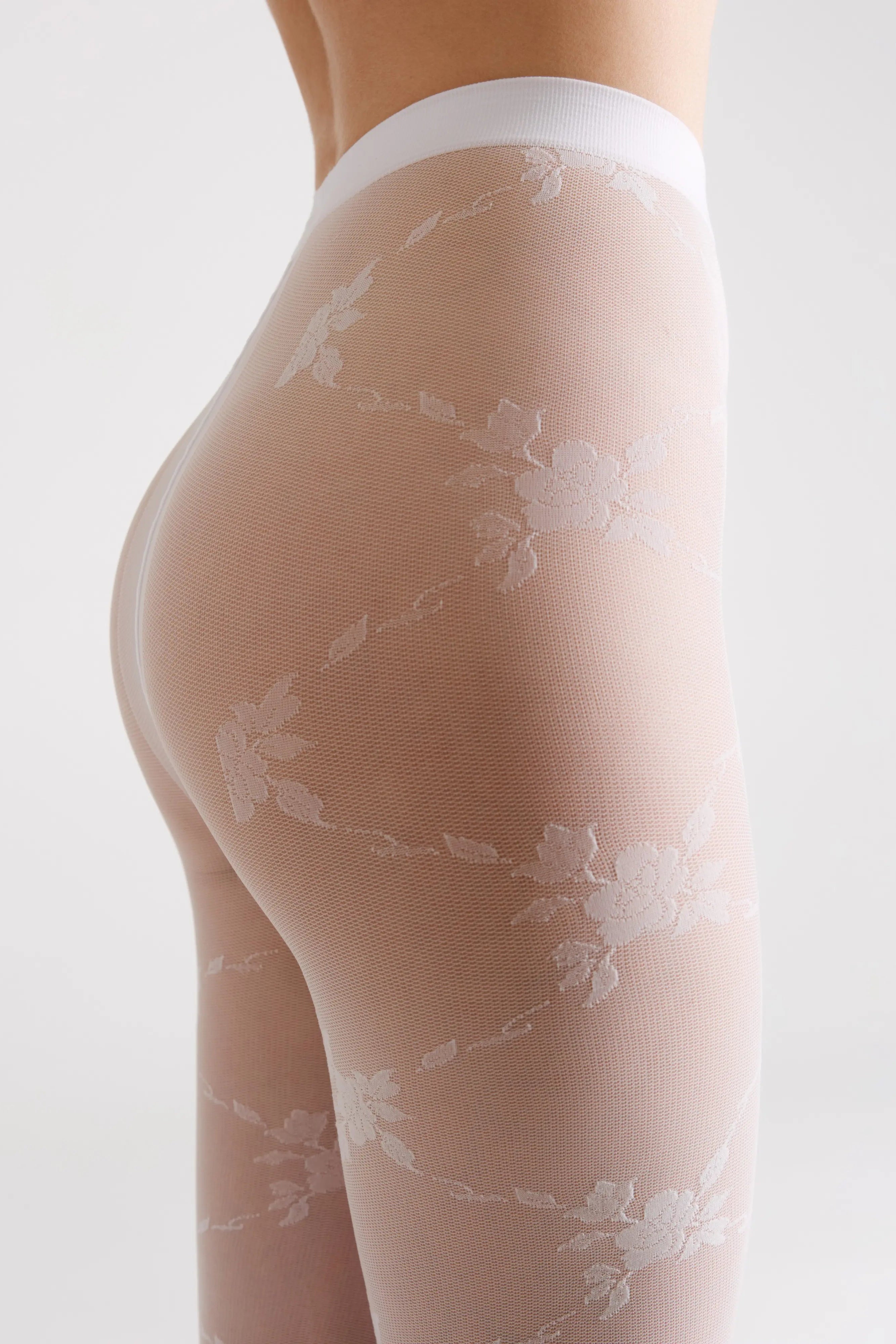 Sheer stockings with floral patterns on a white background