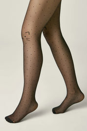 Black polka dot tights worn by a person on a beige background #color_nero-black
