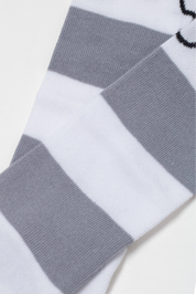 Gray and white striped sock on a light gray background
