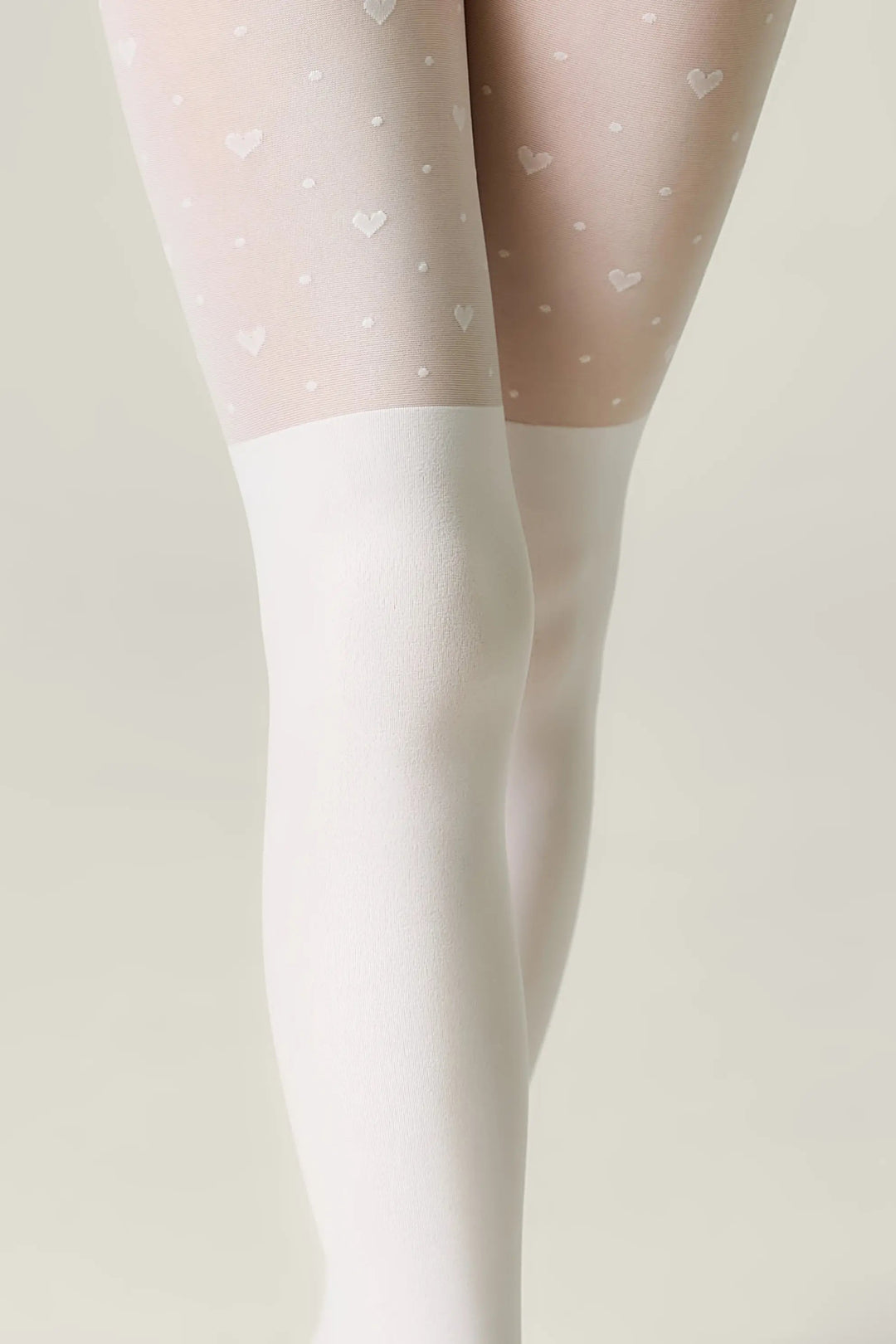 White tights with heart pattern on a neutral background #color_bianco
