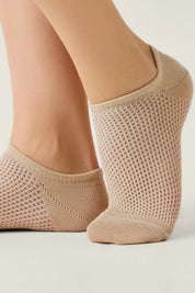 Beige socks worn by a person on a light background  #color_beige