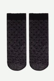 Pair of black socks with a subtle pattern on a white background #color_nero-black