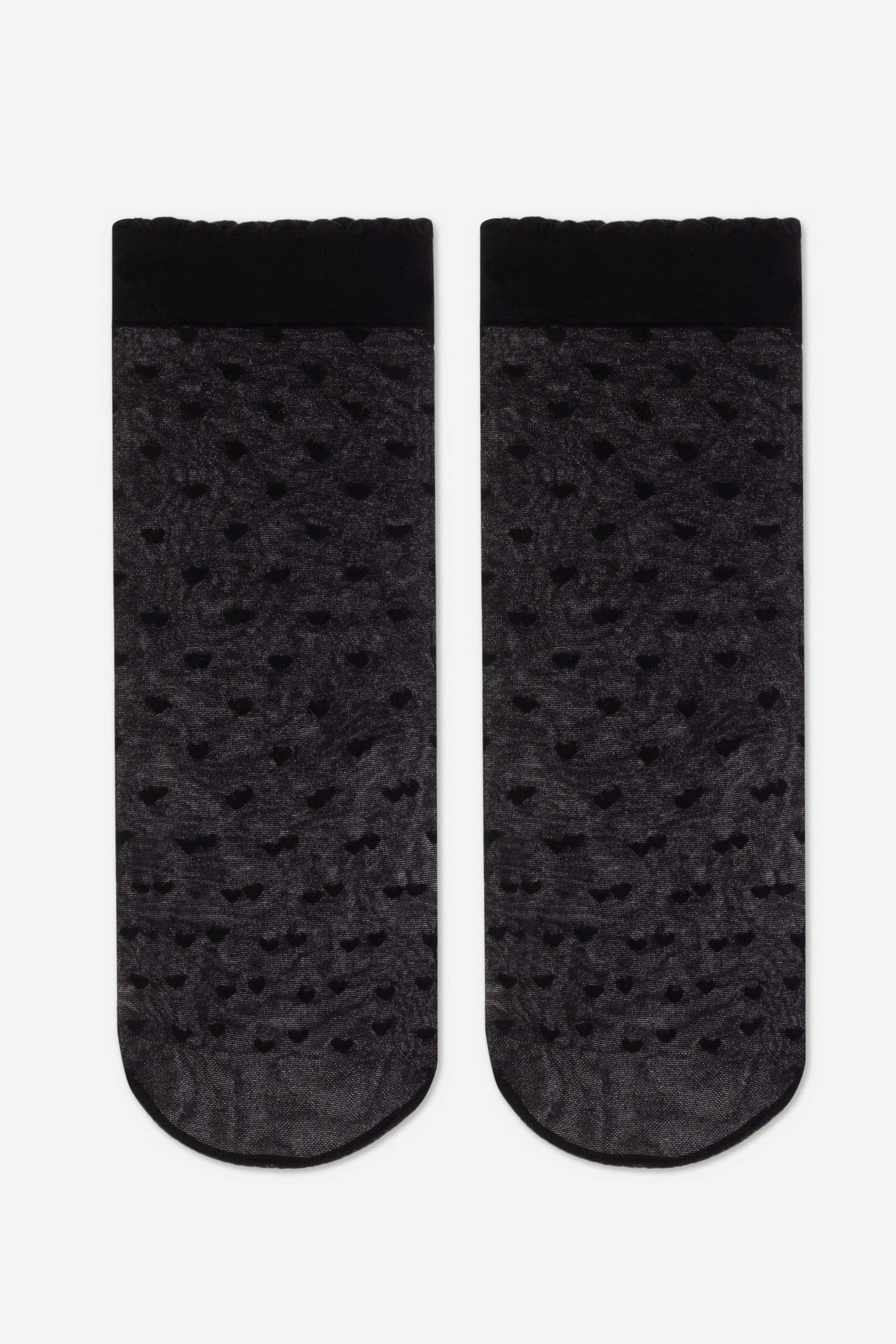Pair of black socks with a subtle pattern on a white background #color_nero-black