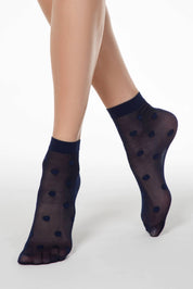 Navy blue polka dot socks worn by a person on a white background #color_marino
