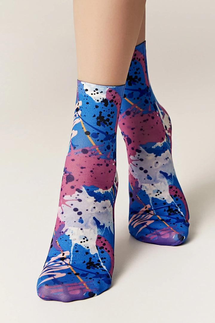 Colorful abstract-patterned socks on a neutral background