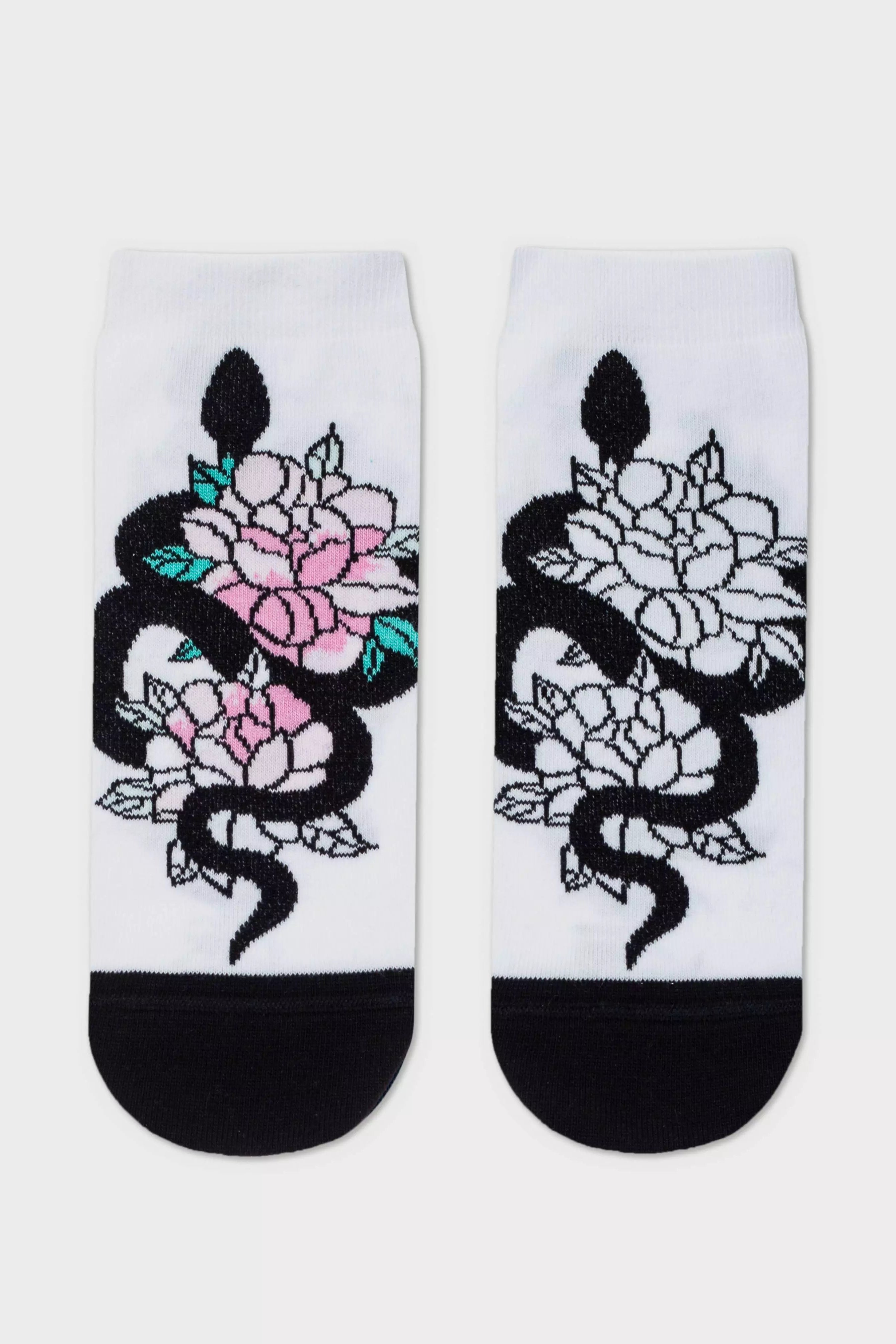 Pair of socks with snake and floral design on a white background