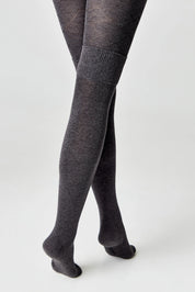 Dark gray tights worn by a person on a white background #color_dark-gray