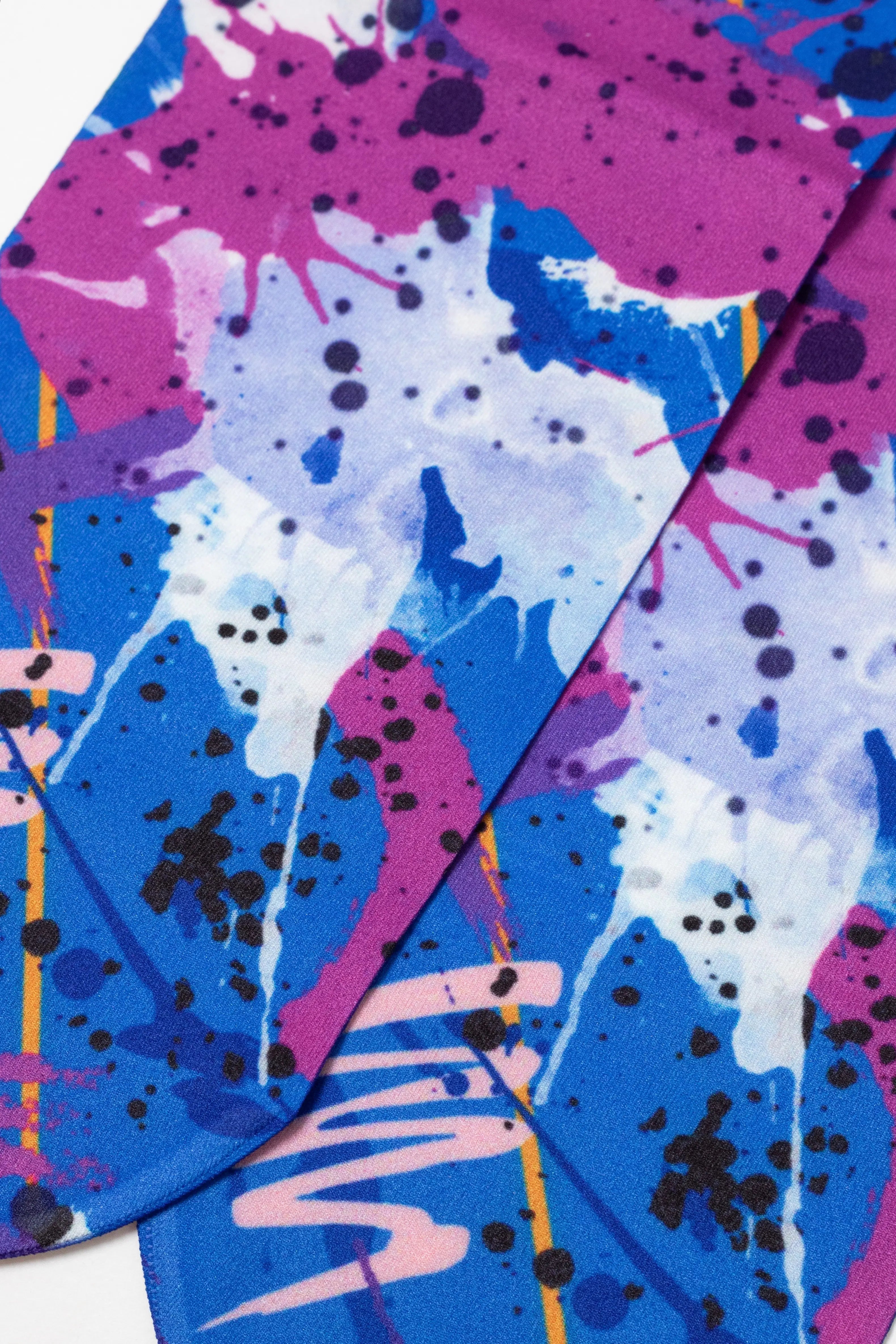 Colorful abstract design with splashes of blue, pink, and black on a white background