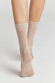 Beige socks worn by a person on a light gray background #color_beige