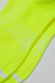 Neon yellow socks with 'Conte' branding on a light gray background #color_lime-green